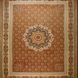 Ornate brown rug with a central star medallion and multi-banded borders in cream, red, and light blue.