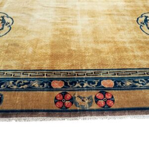 Gold rug featuring twin blue dragon medallions and complex borders with red floral and dark blue geometric patterns.