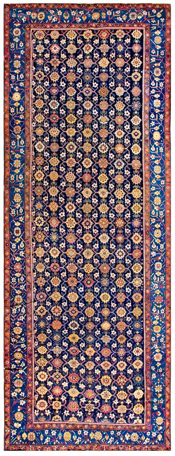 Navy blue runner rug featuring a repeating floral lattice pattern and multiple borders in red and royal blue.