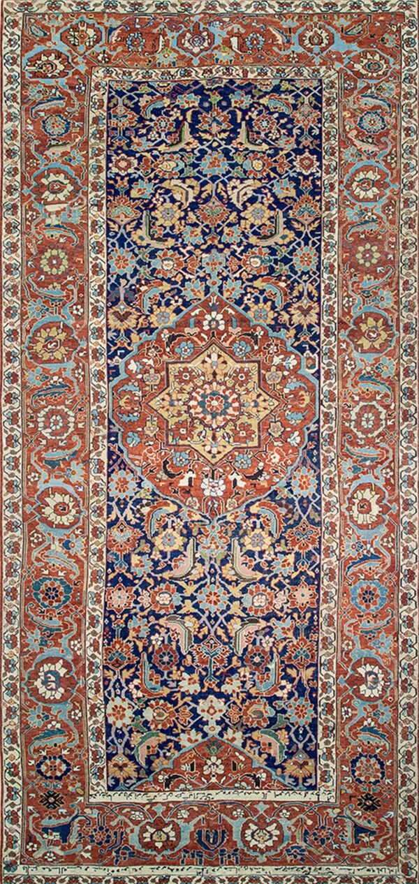 Ornate traditional rug featuring a navy blue field, a central medallion, and complex red, gold, and light blue motifs.