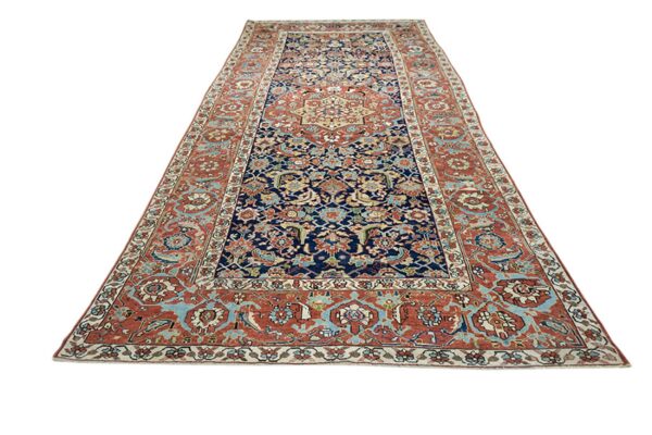 Traditional runner rug featuring a detailed floral pattern in navy blue, rust red, and light blue.