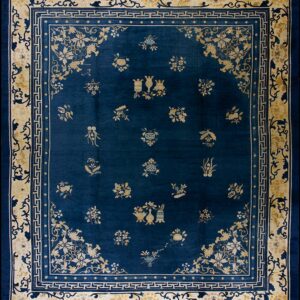 Deep blue rug featuring scattered yellow and cream floral motifs with wide, layered decorative borders.