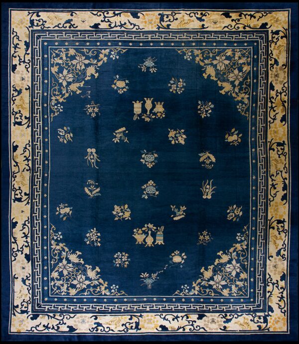Deep blue rug featuring scattered yellow and cream floral motifs with wide, layered decorative borders.
