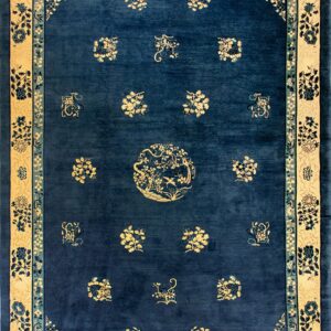 Traditional dark blue rug with a wide tan border and scattered yellow and light blue floral designs.