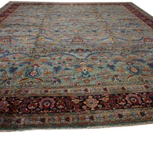 Ornate floral rug with a teal blue-green field and multi-colored navy and maroon borders.