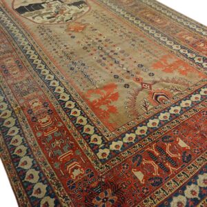 Tan central field rug with wide complex red and blue geometric borders and a central figural medallion.