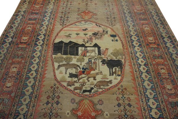 Beige rug featuring a detailed pictorial medallion with figures and animals, framed by red and navy borders.