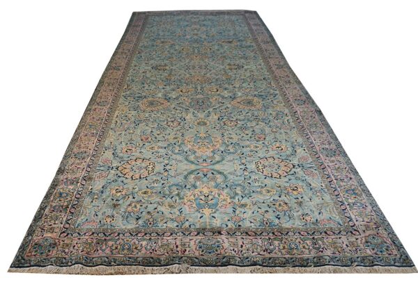 Long runner rug featuring an elaborate traditional pattern in soft blue, pink, and gold tones.