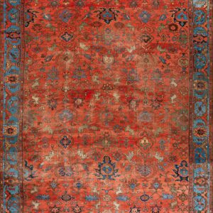 Distressed red rug with an all-over intricate pattern and wide, decorative turquoise blue border.