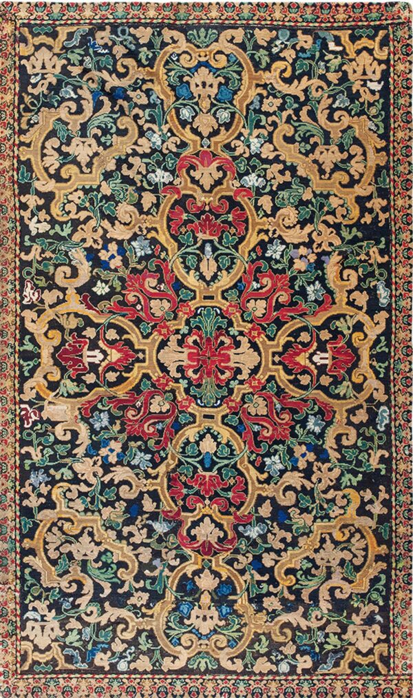 Ornate traditional rug featuring a dark ground, central medallion, and elaborate scrolling floral motifs in red, gold, and green.