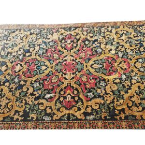 Ornate area rug featuring a black field with sprawling gold scrollwork and vibrant red floral motifs.