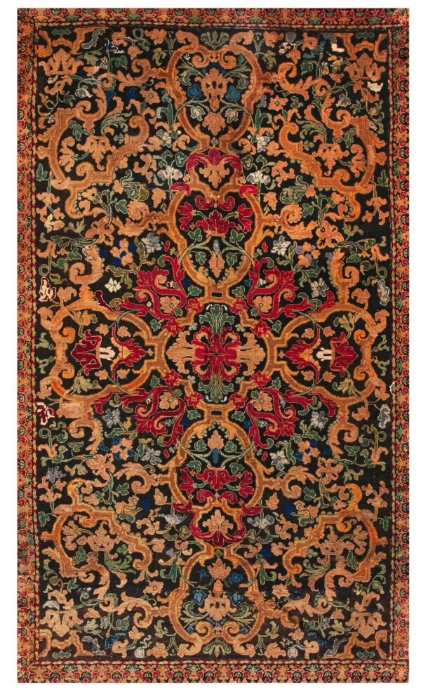 Highly detailed rug featuring gold, red, and green symmetrical floral and vine patterns on a black field.