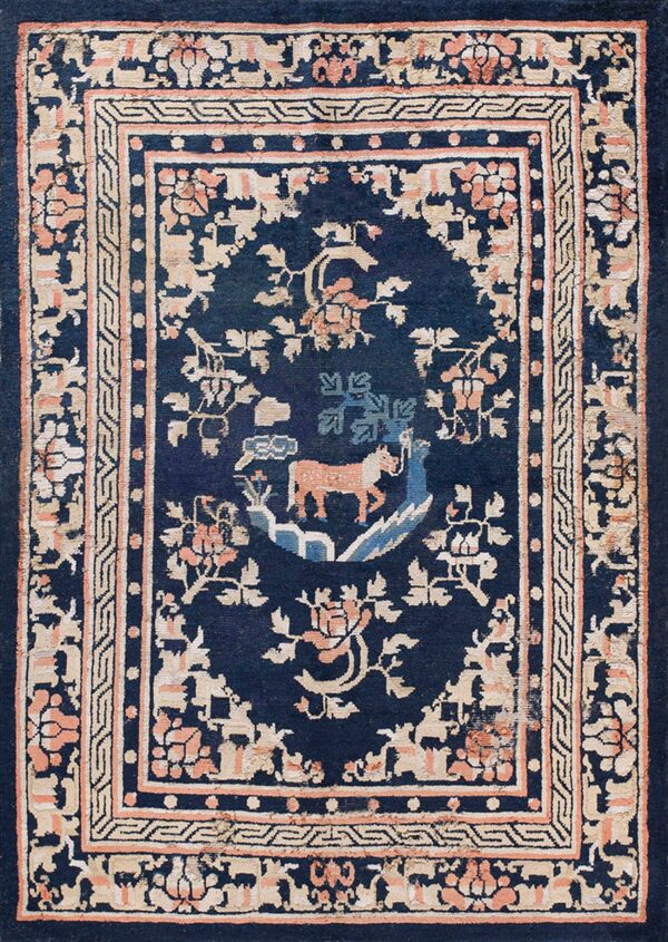 Dark blue rug with a beige and coral floral border surrounding a central medallion with an orange animal.