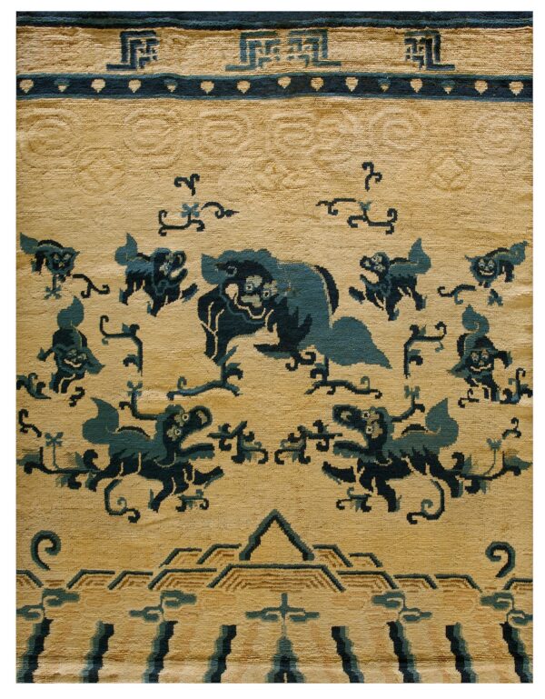 Tan and dark blue rug detail showing stylized mythological animals, cloud motifs, and a geometric key border.