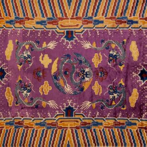 Violet rug with blue and white dragons, framed by an intricate, multi-hued border of orange, blue, and maroon stripes.