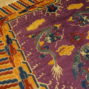 Purple rug featuring blue dragons, yellow clouds, and a multi-colored geometric border on wood flooring.