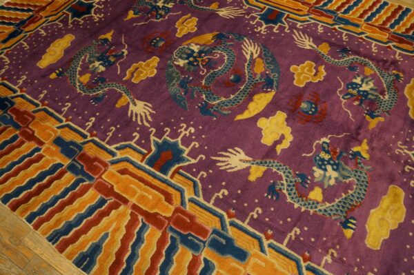 Purple dragon-patterned rug with blue, yellow, and red accents, featuring a multi-colored geometric border on wood flooring.
