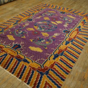 Vibrant purple dragon rug with red, blue, and gold geometric borders on light wood flooring.