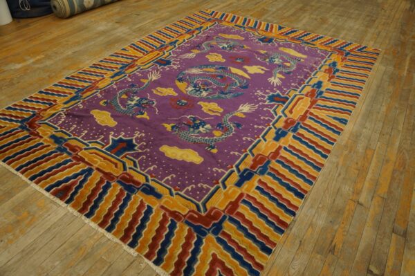 Vibrant purple dragon rug with red, blue, and gold geometric borders on light wood flooring.
