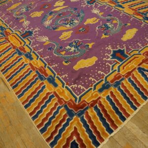 Purple rug with blue dragons and yellow clouds, bordered by geometric red, blue, and gold stripes on wood flooring.