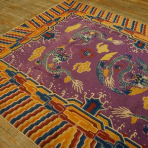 Magenta rug with blue dragon pattern and multicolored striped borders rests on a wooden floor.