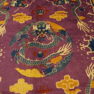 Purple rug detailed with blue dragons, yellow clouds, red accents, and a complex geometric border.
