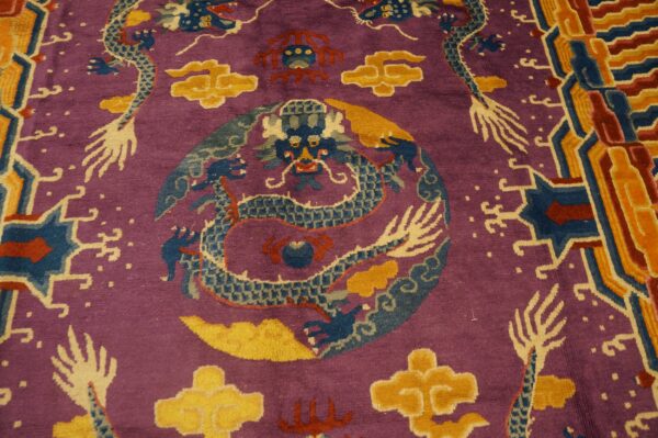 Purple rug detailed with blue dragons, yellow clouds, red accents, and a complex geometric border.