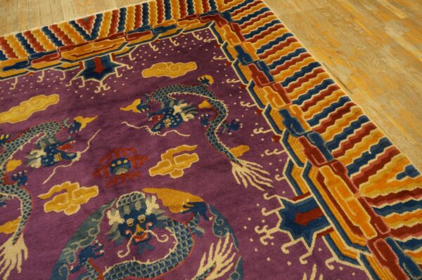 Purple rug with blue dragon and yellow cloud pattern, framed by a colorful striped border on wood flooring.