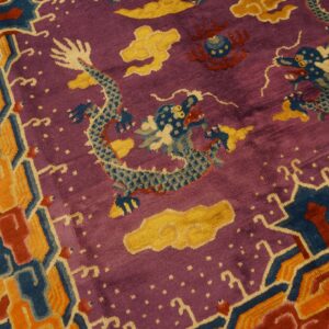 Purple, shaggy rug with blue dragon and yellow cloud motifs, framed by a thick geometric border.