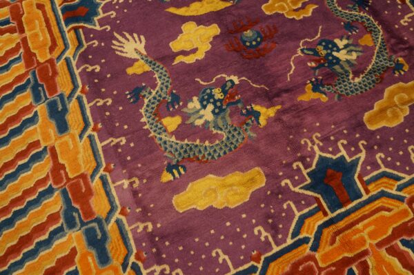 Purple, shaggy rug with blue dragon and yellow cloud motifs, framed by a thick geometric border.