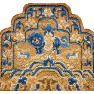 Shaped gold and blue rug detail with a shaggy texture and stylized lion motifs.