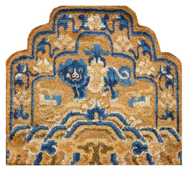 Shaped gold and blue rug detail with a shaggy texture and stylized lion motifs.