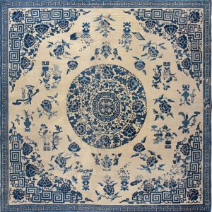 Intricate blue and cream rug with a central medallion and detailed geometric meander borders.