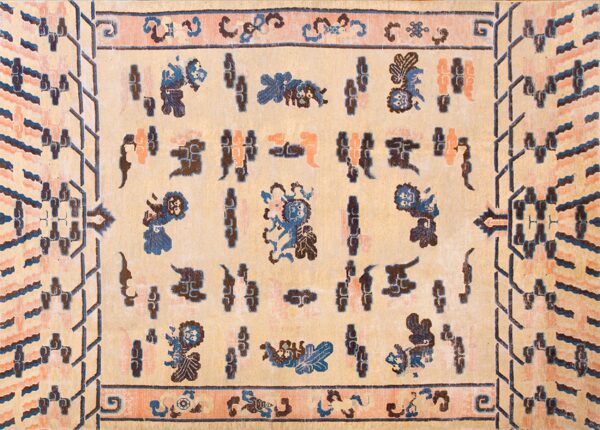 A light tan rug with indigo blue, coral, and brown folkloric designs and geometric borders.