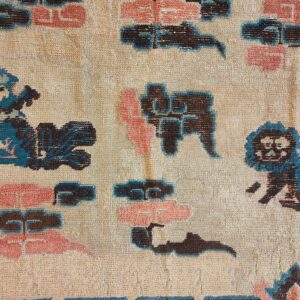 Beige rug detail showing stylized dark brown, teal, and pink cloud and animal motifs.