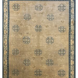 Tan area rug featuring repeating blue medallions and an intricate blue and beige border design.