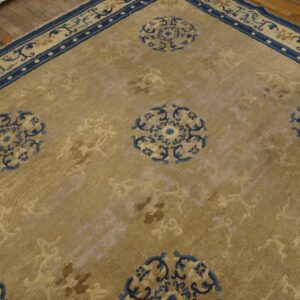 Distressed gold rug with dark blue borders and medallions lies diagonally on rustic hardwood floors.