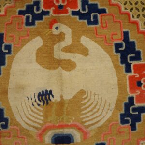 A high-pile rug detail shows a cream bird on gold, bordered by red, blue, and lattice patterns.
