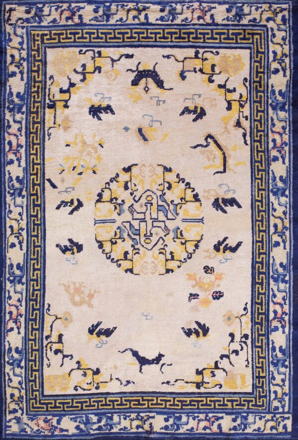 Ivory rug featuring a dark blue greek key border and a central medallion with yellow and blue stylized designs.