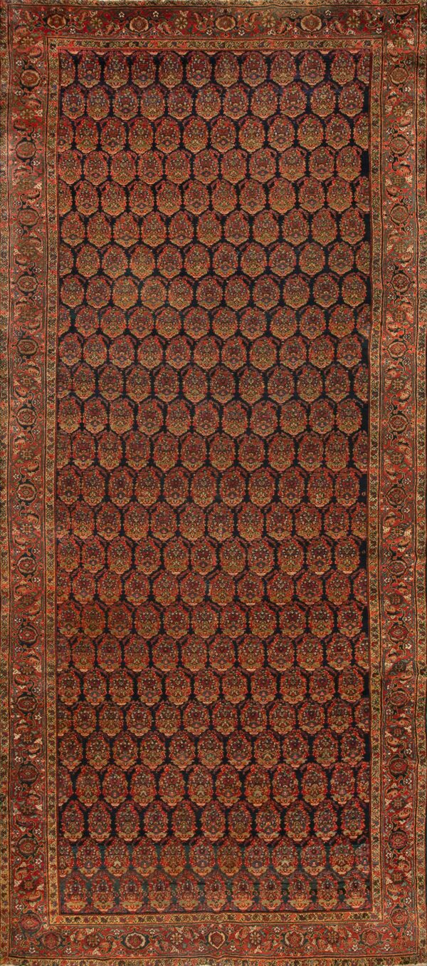 Traditional dark navy rug with a dense repeating pattern of red and gold boteh shapes and a wide red border.