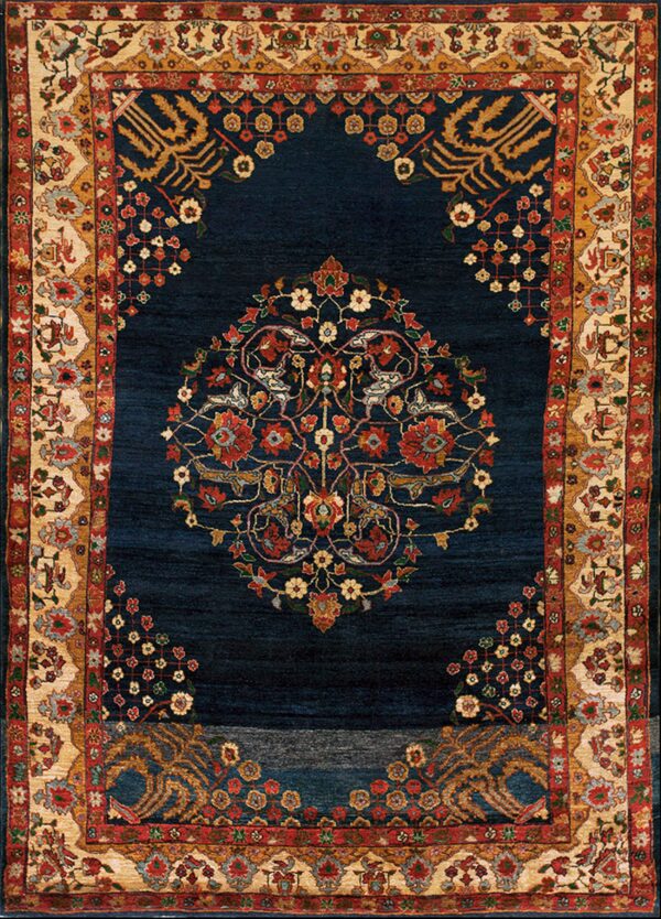 A navy blue rug featuring an intricate red and gold floral medallion and complex beige, red, and gold borders.