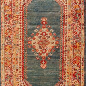 Traditional rug with a diamond-shaped teal field, featuring red, gold, and cream ornate borders and motifs.