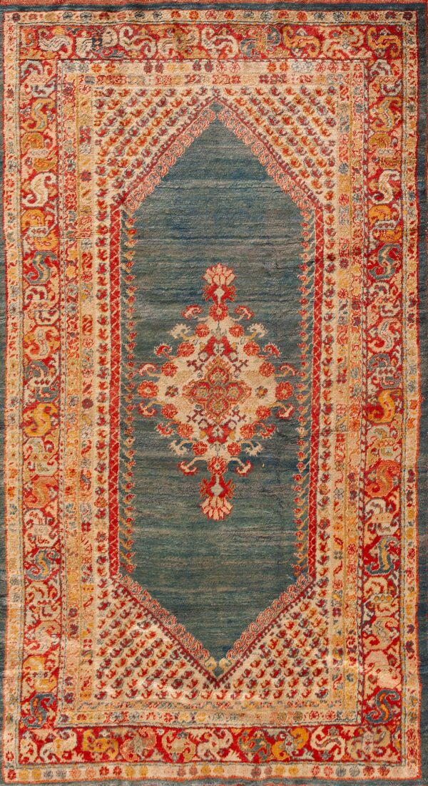 Traditional rug with a diamond-shaped teal field, featuring red, gold, and cream ornate borders and motifs.