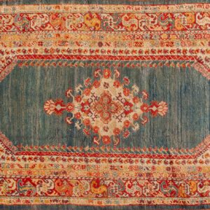 Ornate medallion rug featuring a striated teal ground and borders in red, cream, and gold tones.