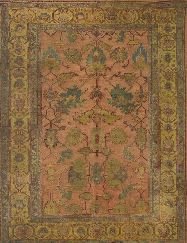 Low-pile salmon-toned rug with an all-over floral pattern and a wide olive green border.