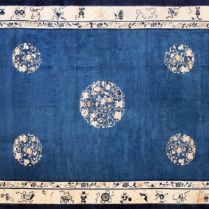 Cobalt blue rug featuring five ivory floral medallions and a broad border with scattered symbolic motifs.