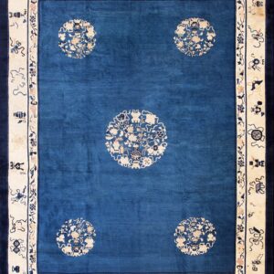 Deep blue rug with cream medallion pattern and light beige border featuring stylized motifs.