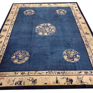 Large blue rug with four cream floral medallions and a wide ornamental cream border.