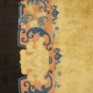 Ornate yellow field with tone-on-tone patterns meets a dark border section featuring blue and coral scroll motifs.