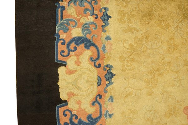 Ornate yellow field with tone-on-tone patterns meets a dark border section featuring blue and coral scroll motifs.